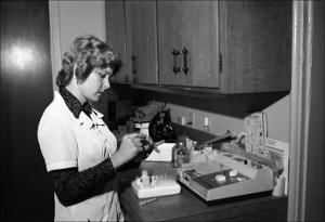 Woman Checks Lab Samples in a Tube   (click for a larger preview)