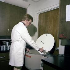 Man Places Sample into a Chamber Type Equipment, number 1   (click for a larger preview)